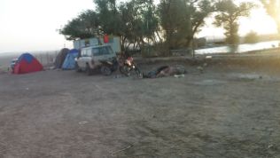 Some people were sleeping in the ground or in a tent near the caravanserai