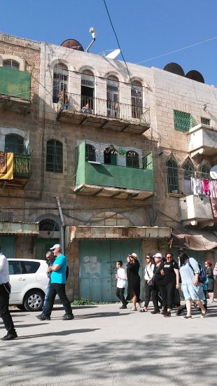 Arab residents of the buildings looking on with frustration